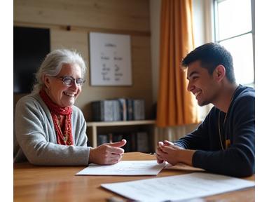 Two individuals engaged in an Indigenous language learning session, possibly with a whiteboard or visual aids