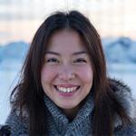 Portrait of delighted Sarah Chen with Arctic background