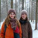 Family portrait of the Jensen family outdoors, smiling in front of a forest